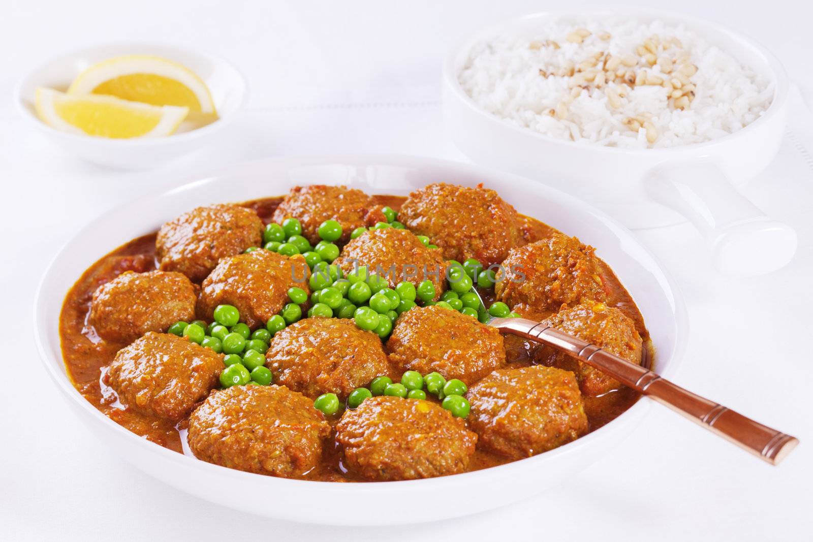 Indian style meatballs in a curry sauce with peas and basmati rice.