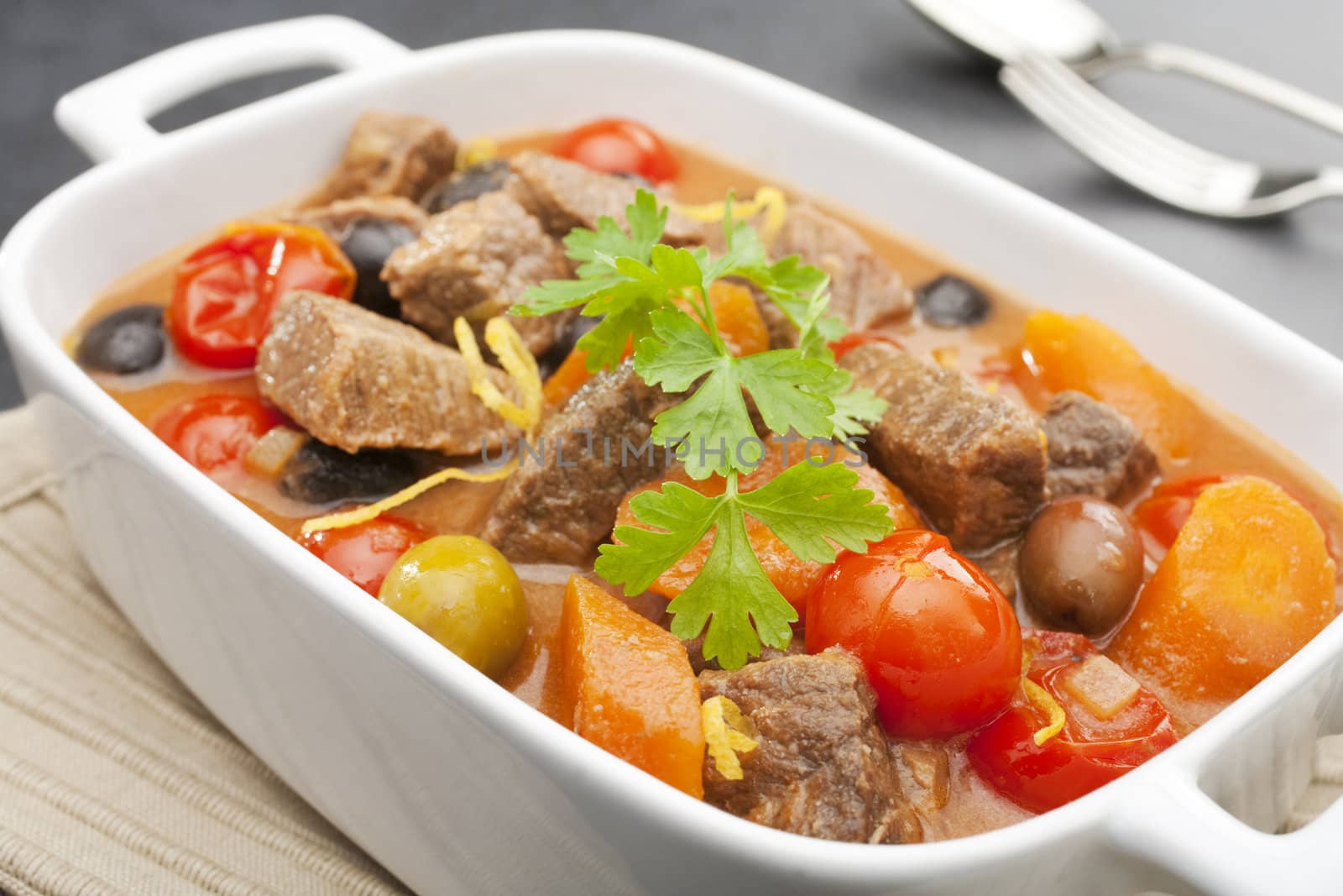 Mediterranean beef stew with olives, tomatoes and carrots, cooked in white wine.