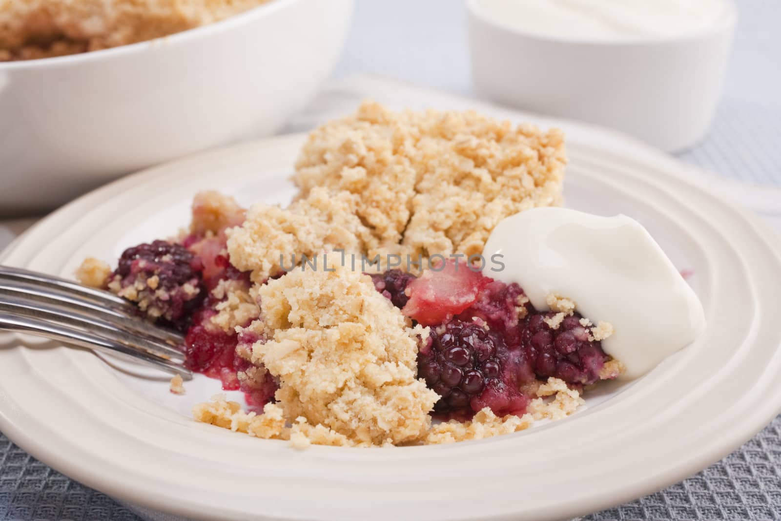 Home baked blackberry and apple crumble with a dollop of Greek yoghurt. Making the most of juicy autumn fruits.