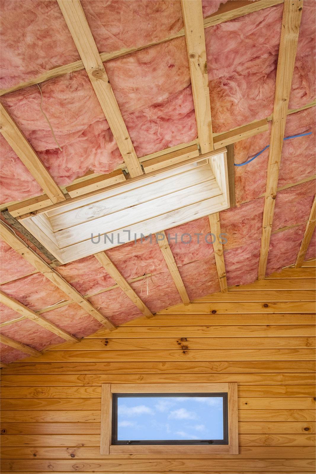 Fibreglass insulation installed in the sloping ceiling of a timber house.