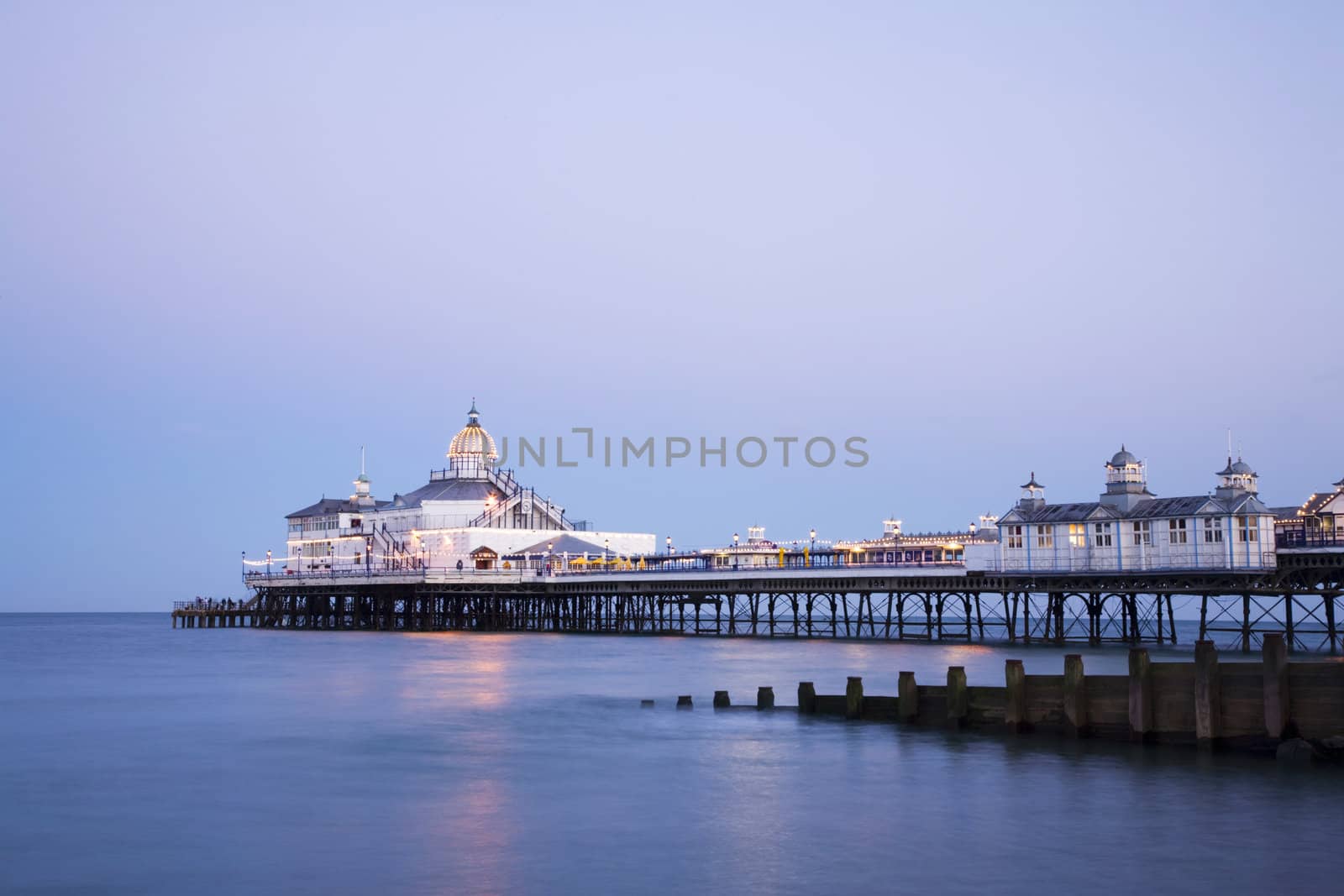 The pier at Eastbourne, Sussex, illuminated at twilight on a perfectly clear summer evening.