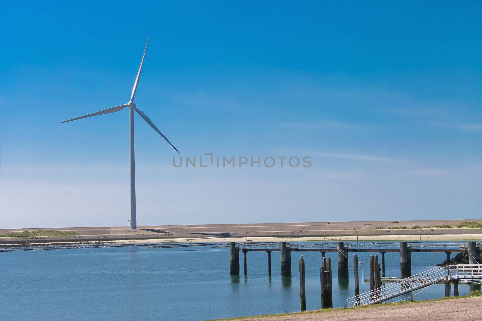 Dutch landscape. Wind turbines on the lake by NickNick
