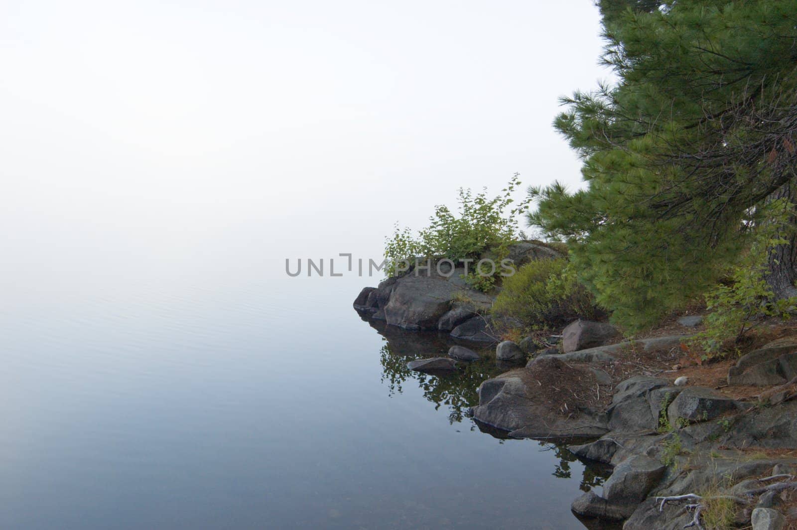 Stones shore of the lake in the erly morning
