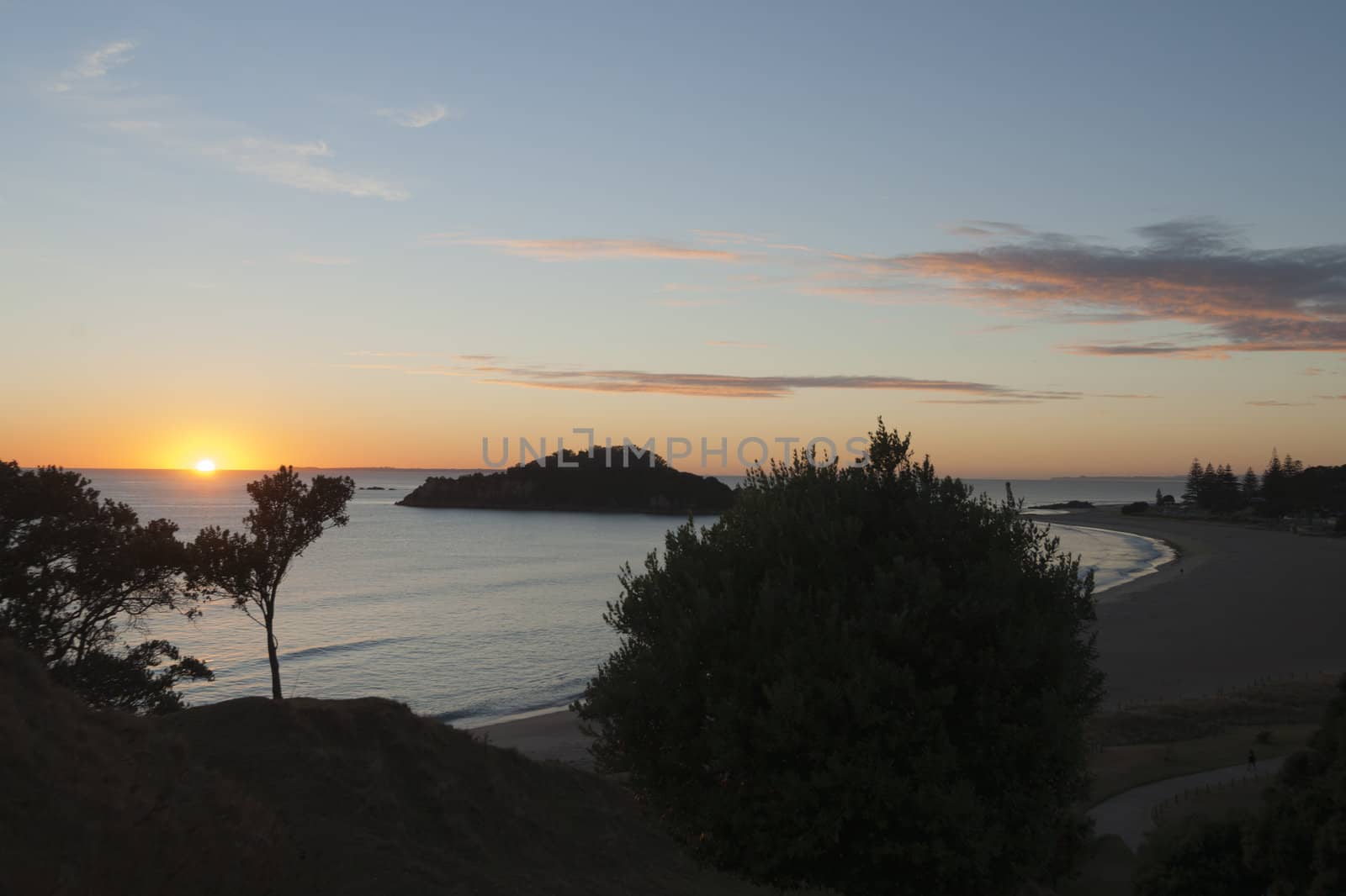Tropical sunrise over beach and sea at Mount maunganui beach, Tauranga.