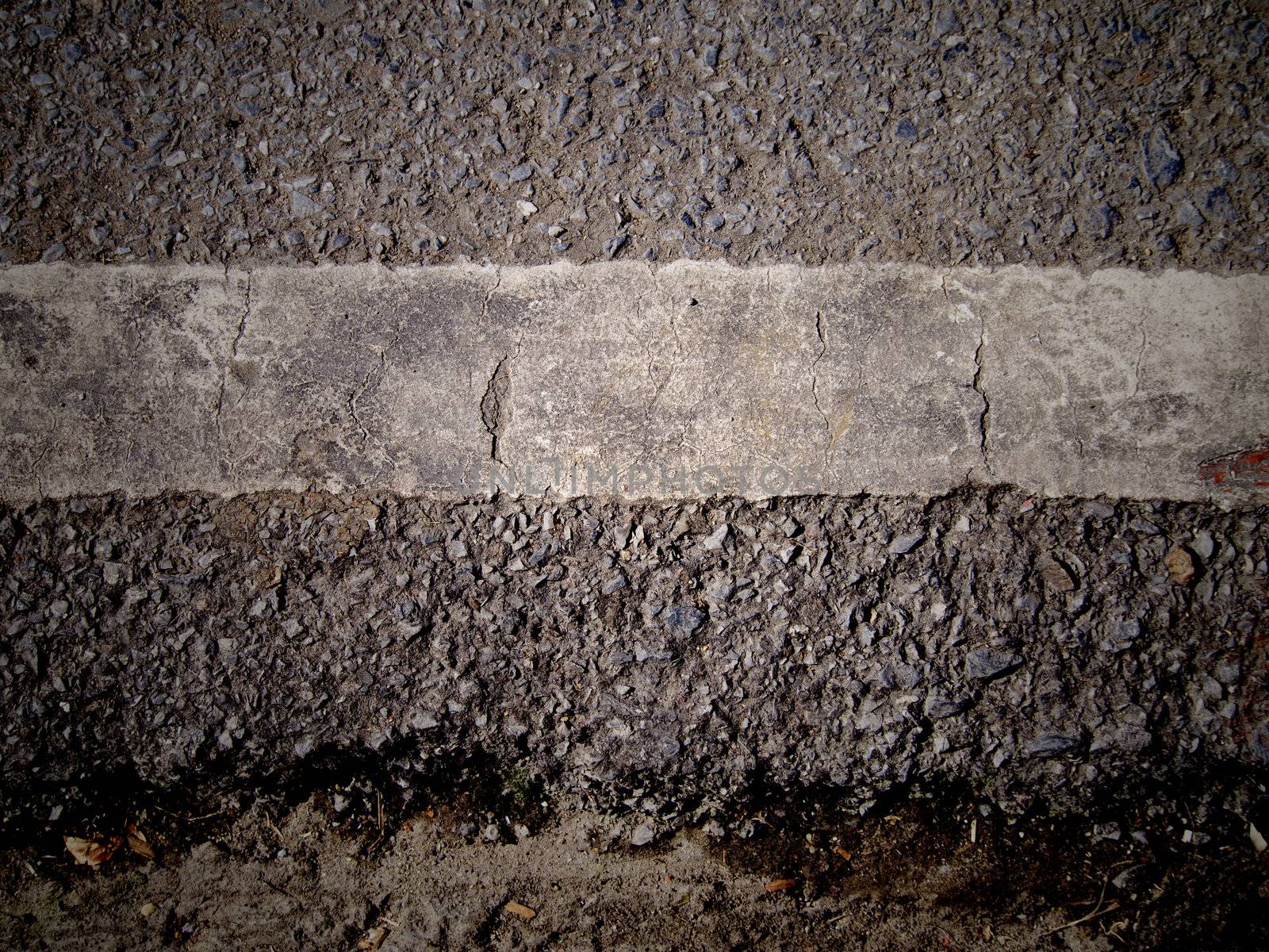 grungy, dirty view of asphalt with distinct white stripe 