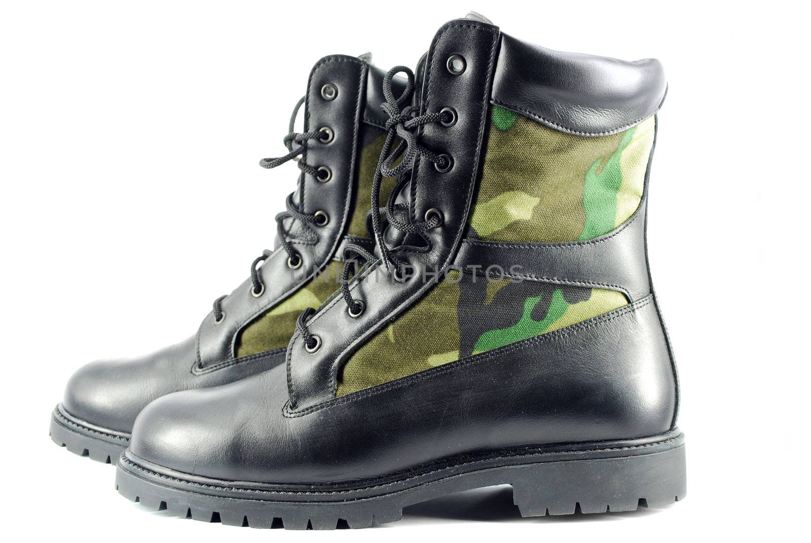 Military camouflage combat boots on white
