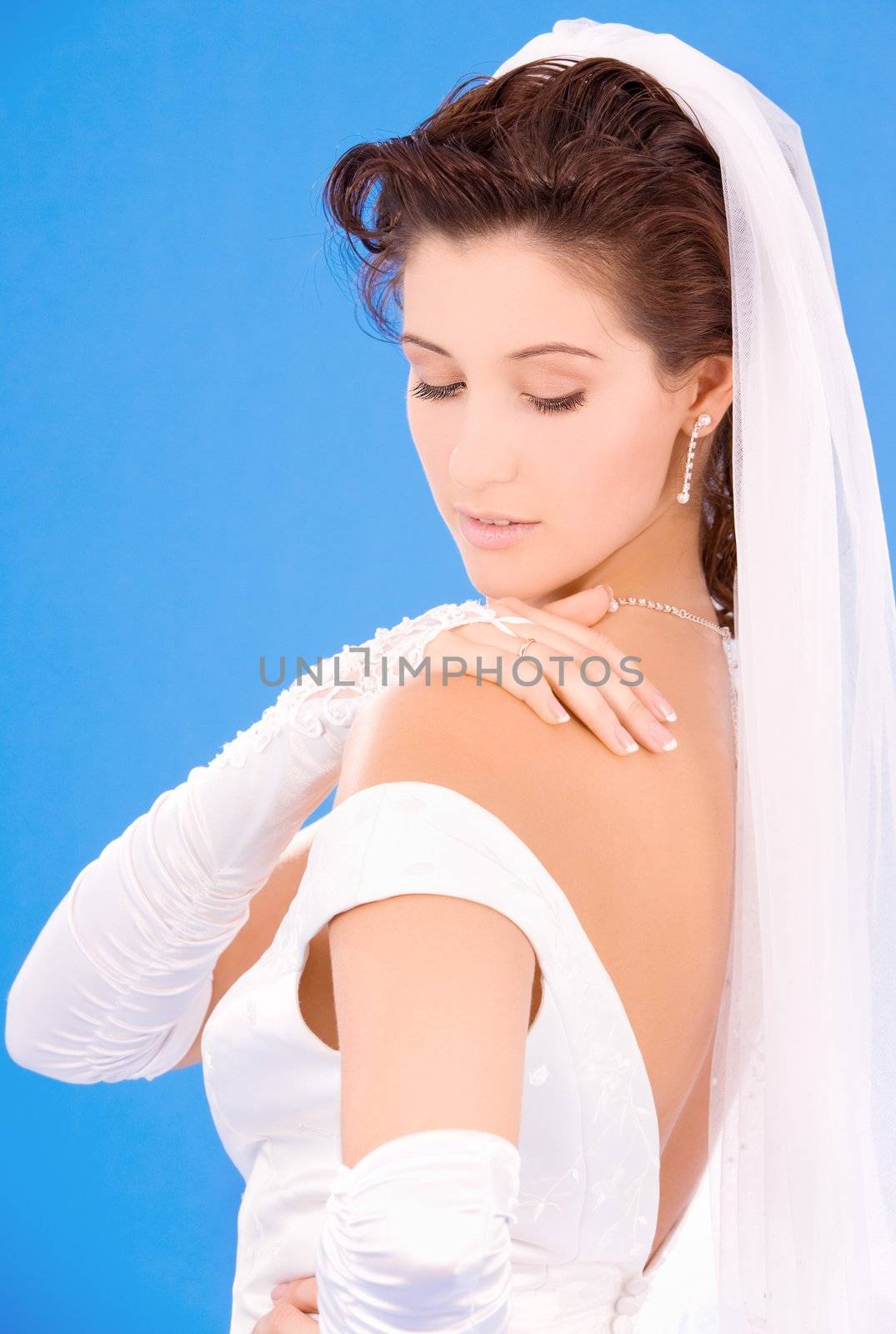 happy bride with her wedding ring over blue