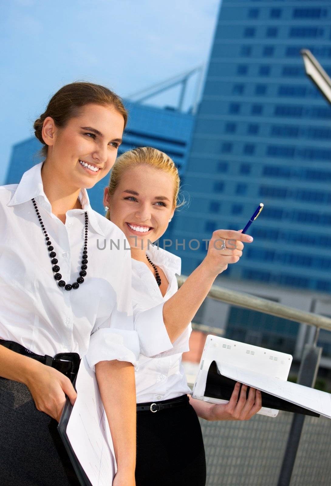 two happy businesswomen by dolgachov