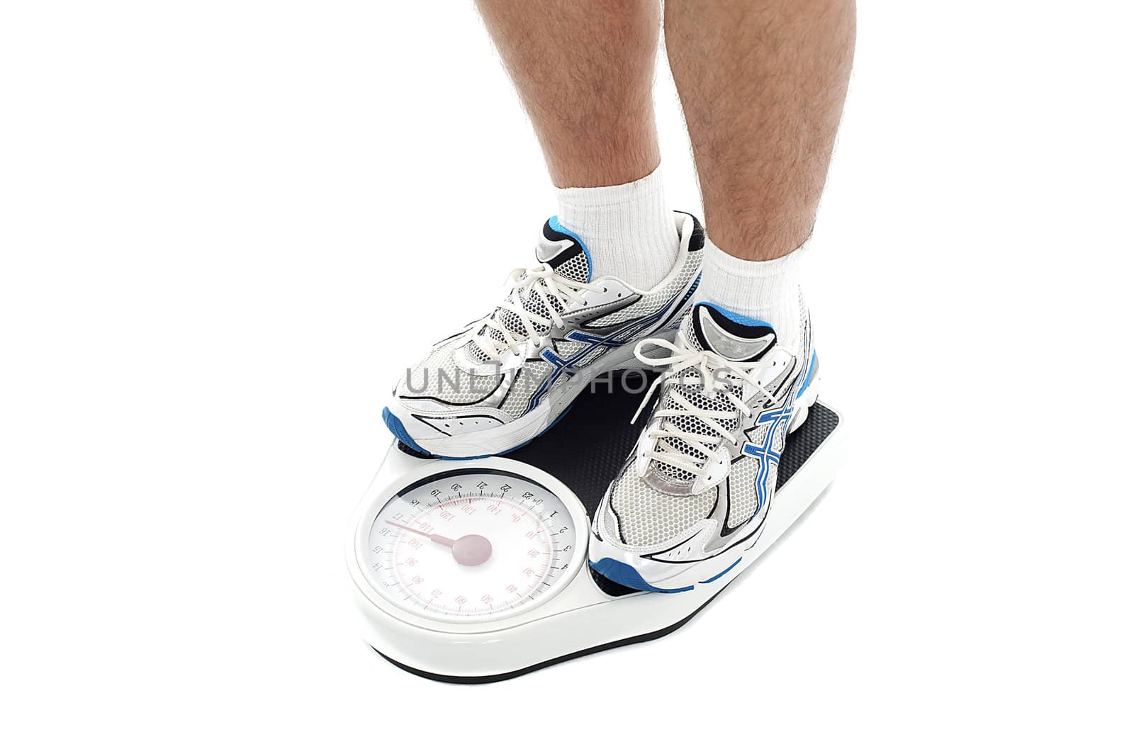 Male person standing on weighing scale. Extreme closeup. All on white background