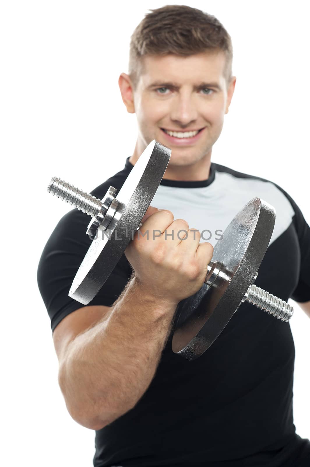 Cheerful young gym instructor posing with heavy dumbbell over white background