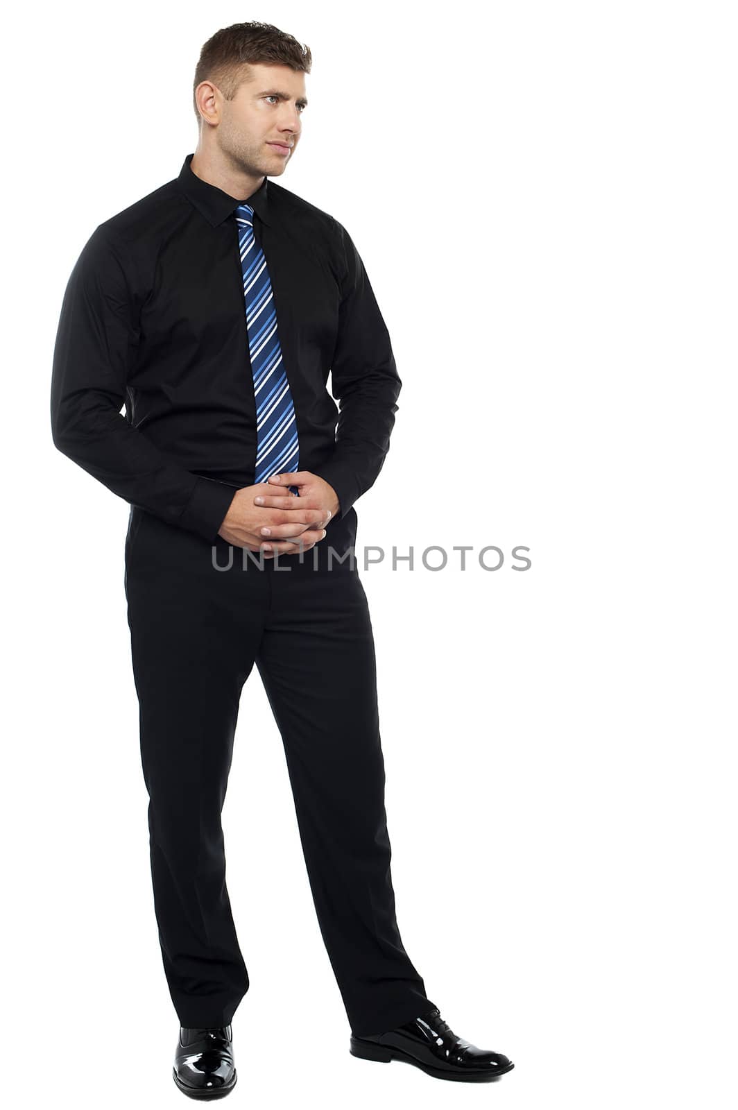 Thoughtful serious businessman. Full length portrait