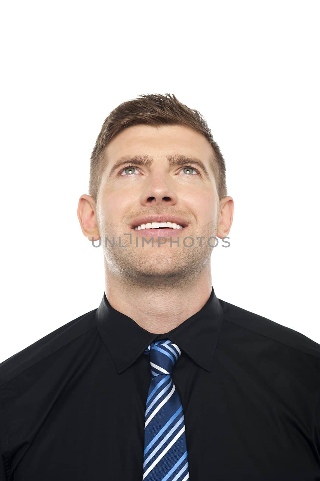 Smiling male executive looking upwards isolated over white background