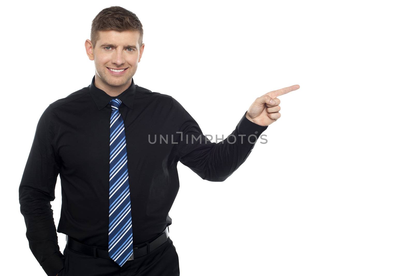Cheerful business consultant pointing at the copy space area isolated against white background
