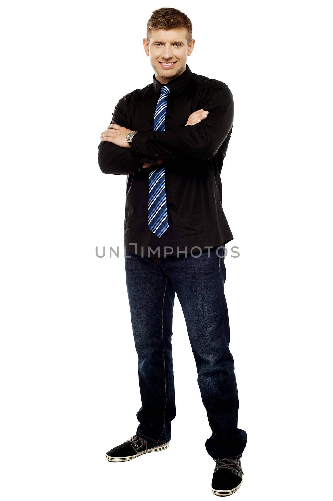 Handsome young male executive with folded arms, full length portrait