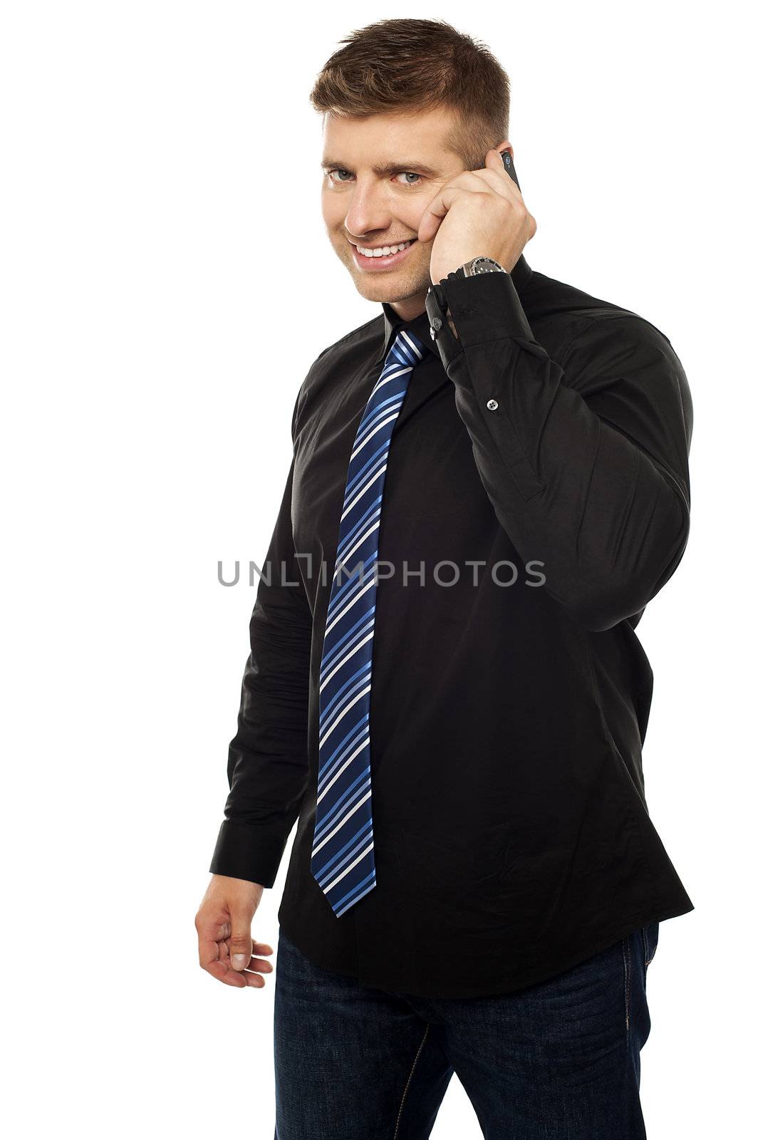 Cool young company CEO communicating via cellphone isolated against white