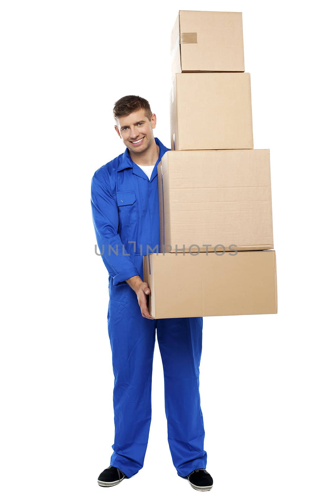 Full length portrait of delivery guy holding pile of cardboard boxes