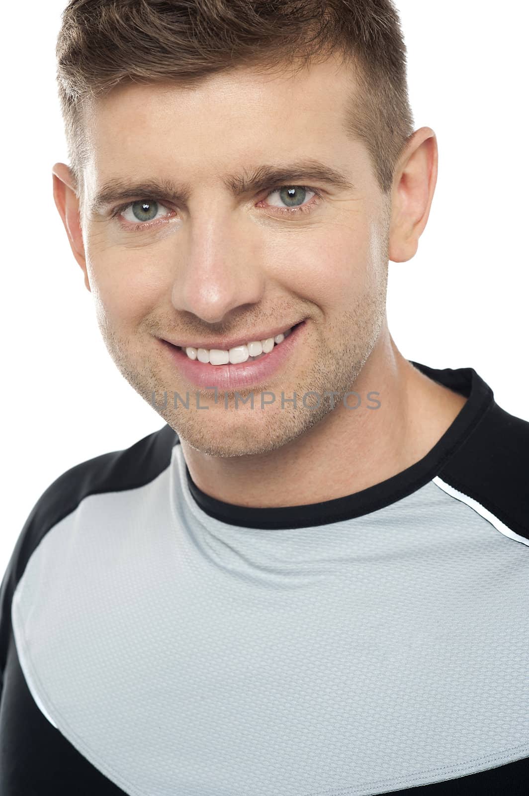 Young cheerful caucasian male in sportswear, closeup shot. Isolated on white