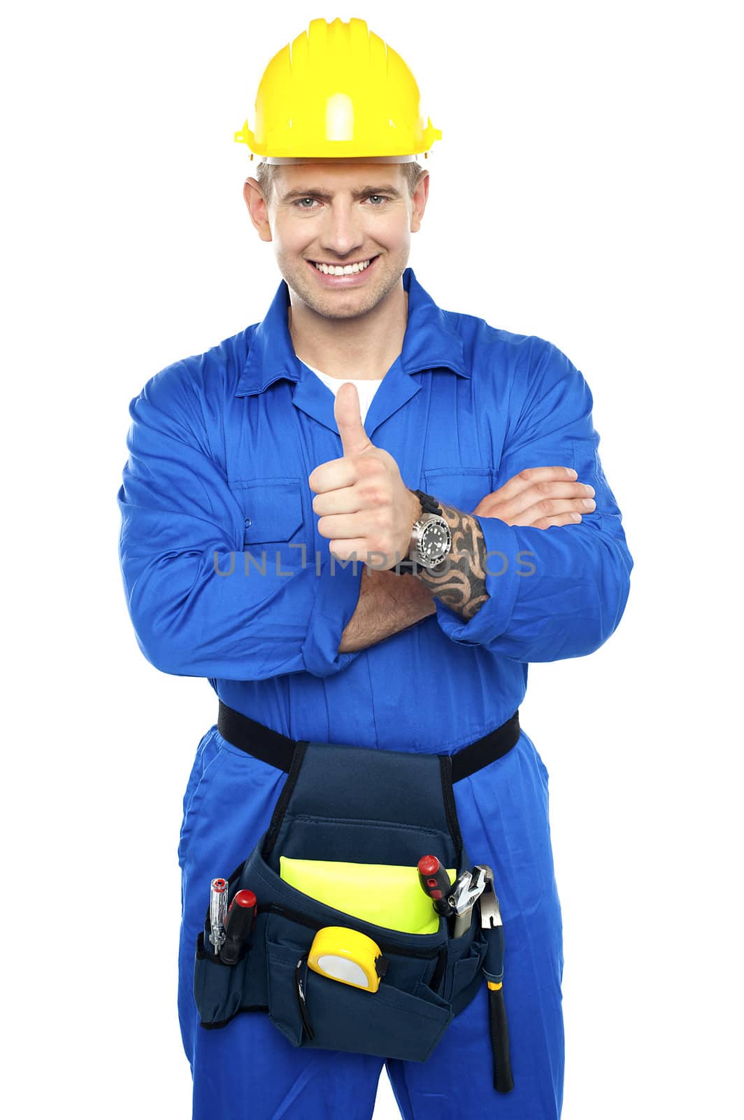 Smiling young industrial contractor showing thumbs up to camera