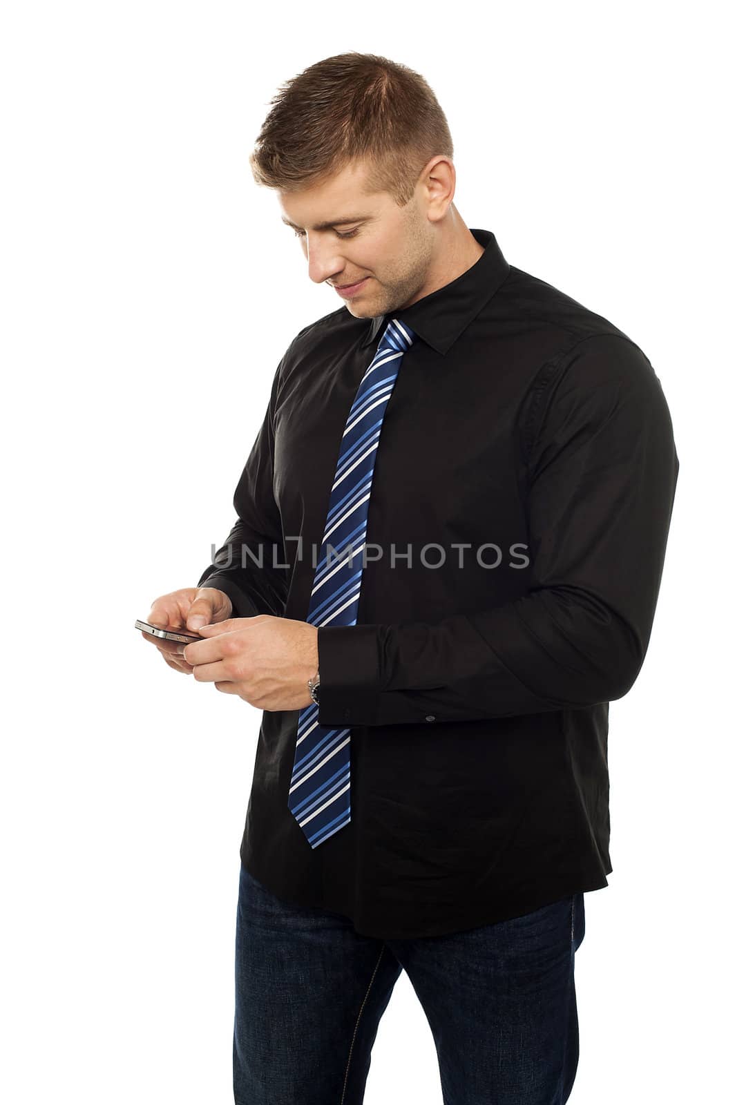 Young businessperson browsing in his cell phone isolated on white
