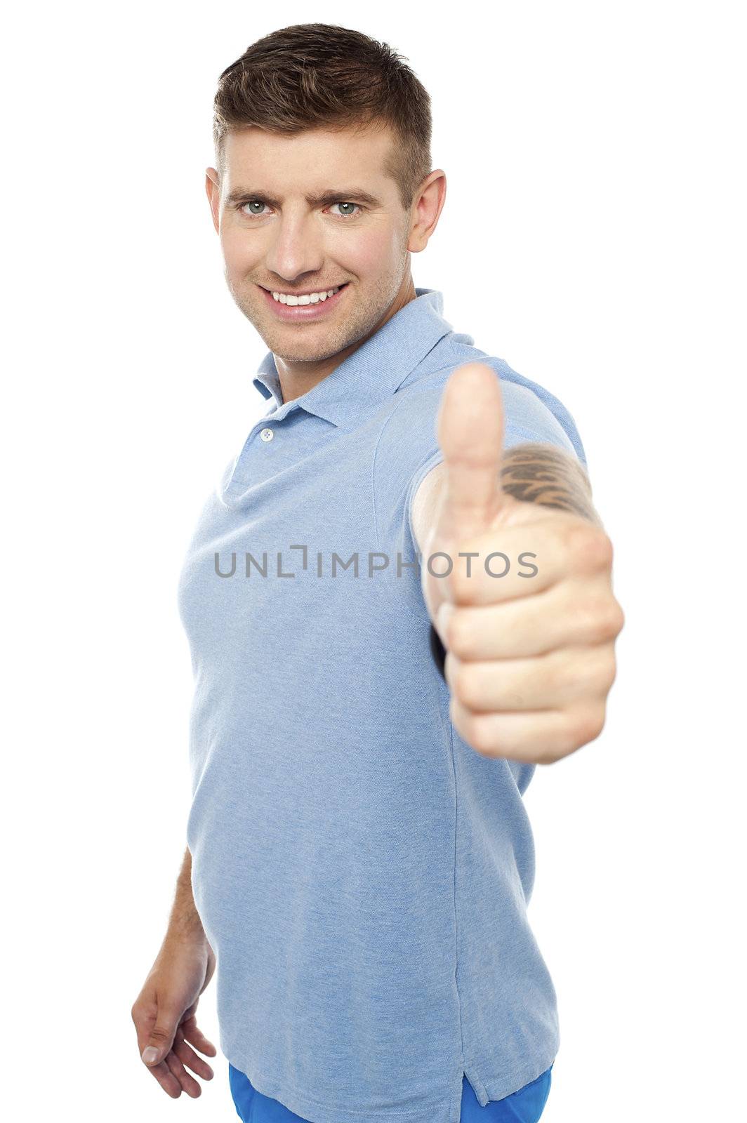 Handsome caucasian male showing  thumbs up to you