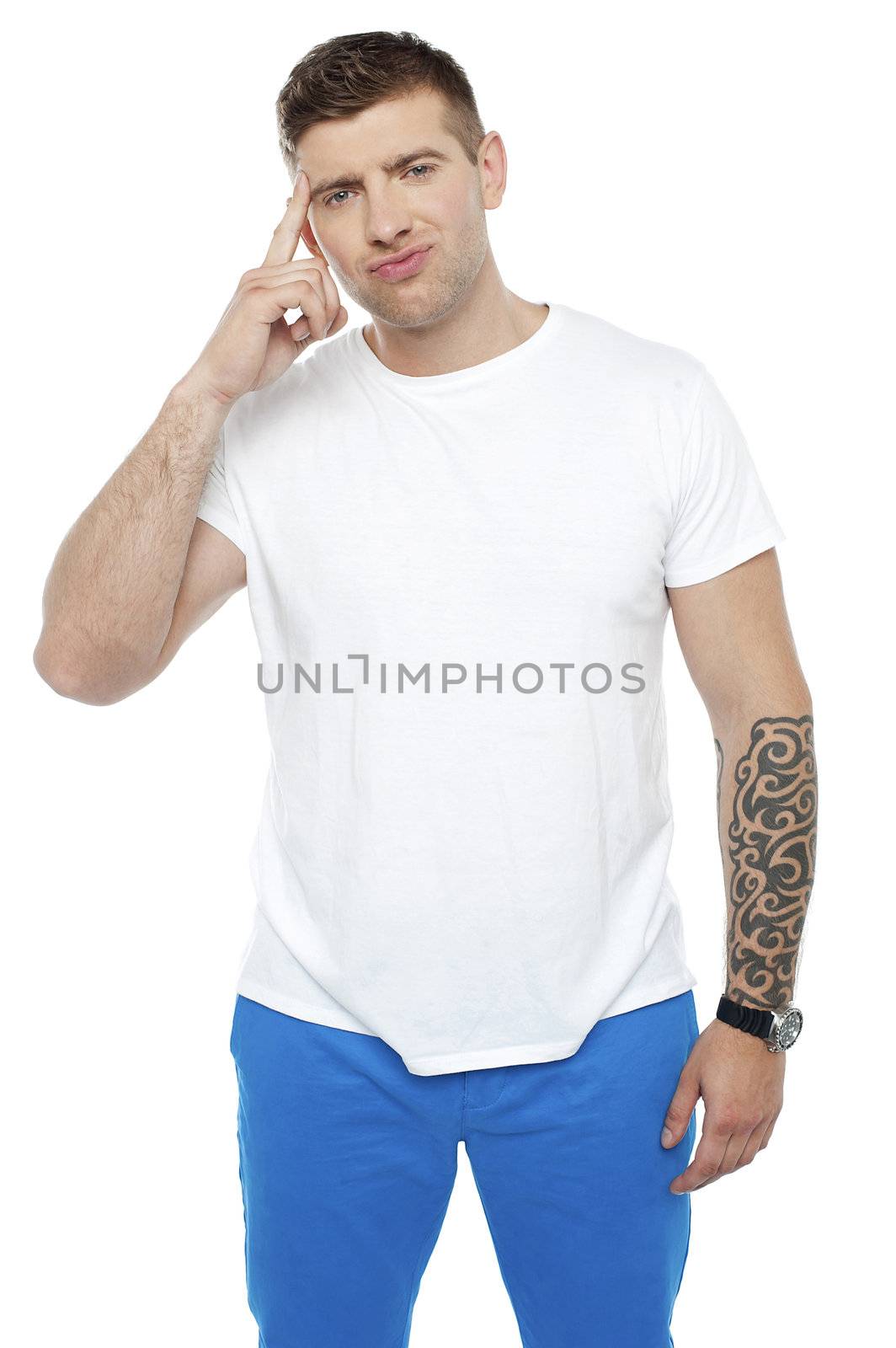 Casual young smart guy thinking hard while looking at camera