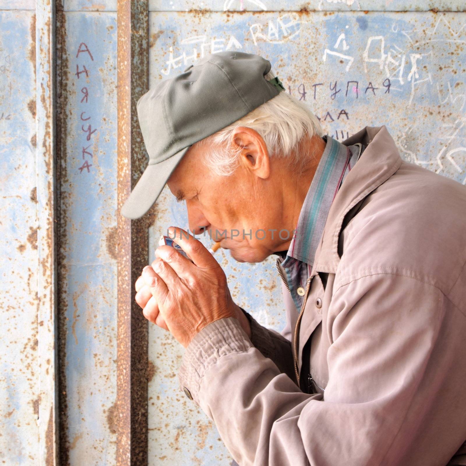 senior lights a cigarette