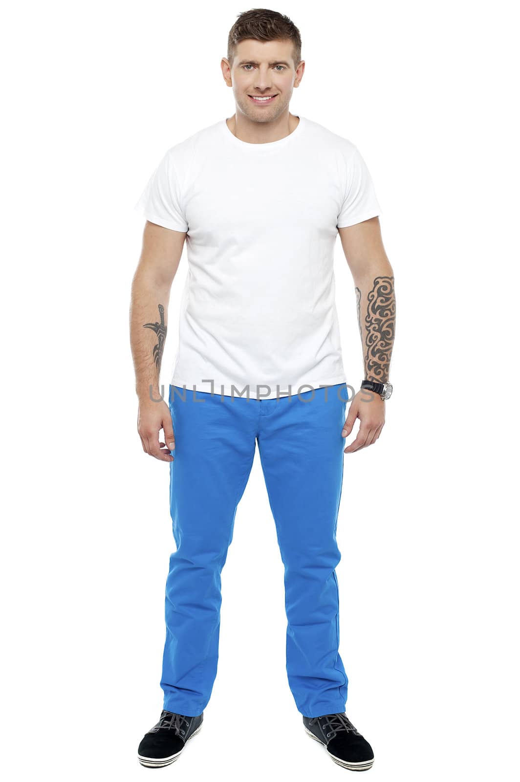 Handsome guy with tattoos posing casually isolated against white background