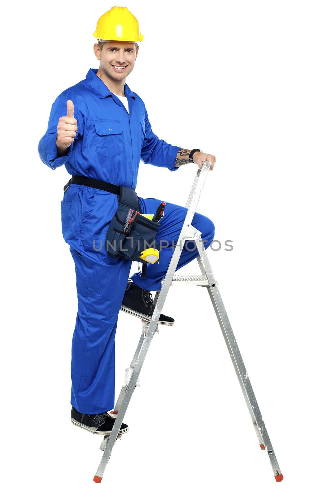 Industrial contractor gesturing thumbs up while climbing on the ladder
