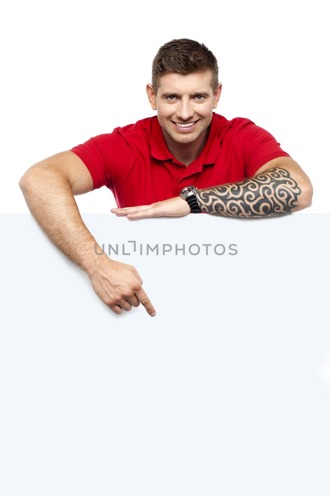 Young man behind whiteboard pointing at it. Tattoo on hand