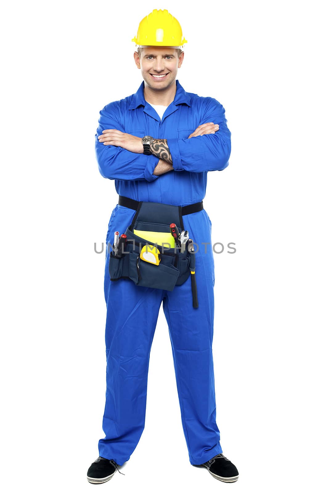 Confident young industrial contractor posing with folded arms