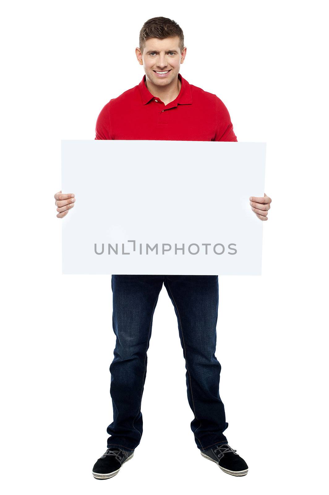 Handsome guy presenting blank billboard to camera isolated against white background
