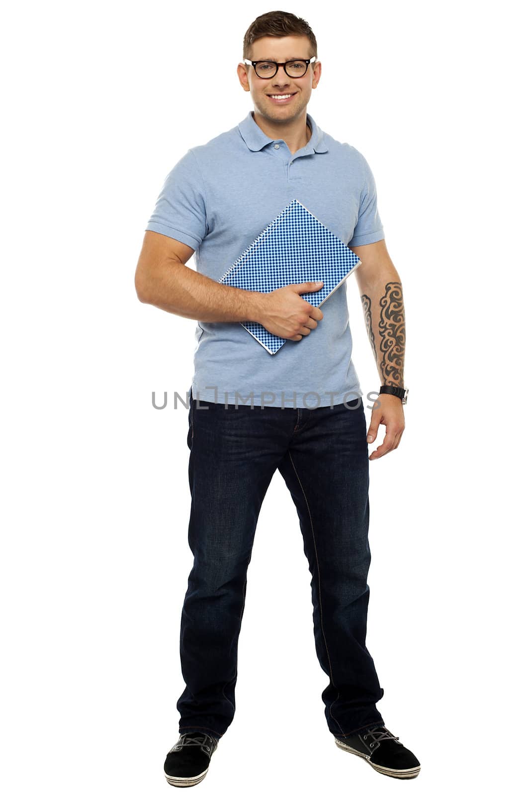 Full length portrait of casual young guy holding notebook