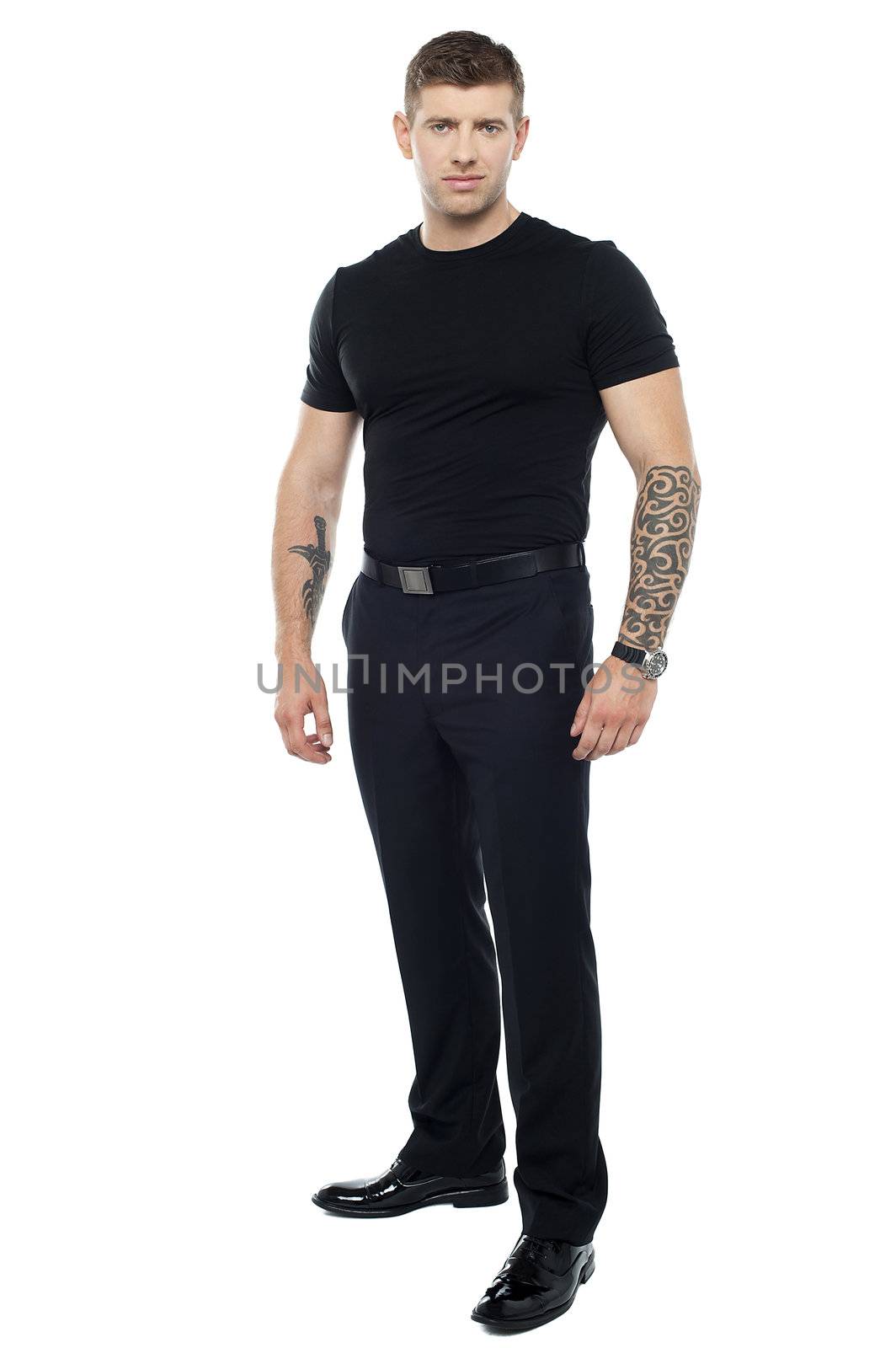 Strong male bouncer. Tattoo on both his hands. Full length shot