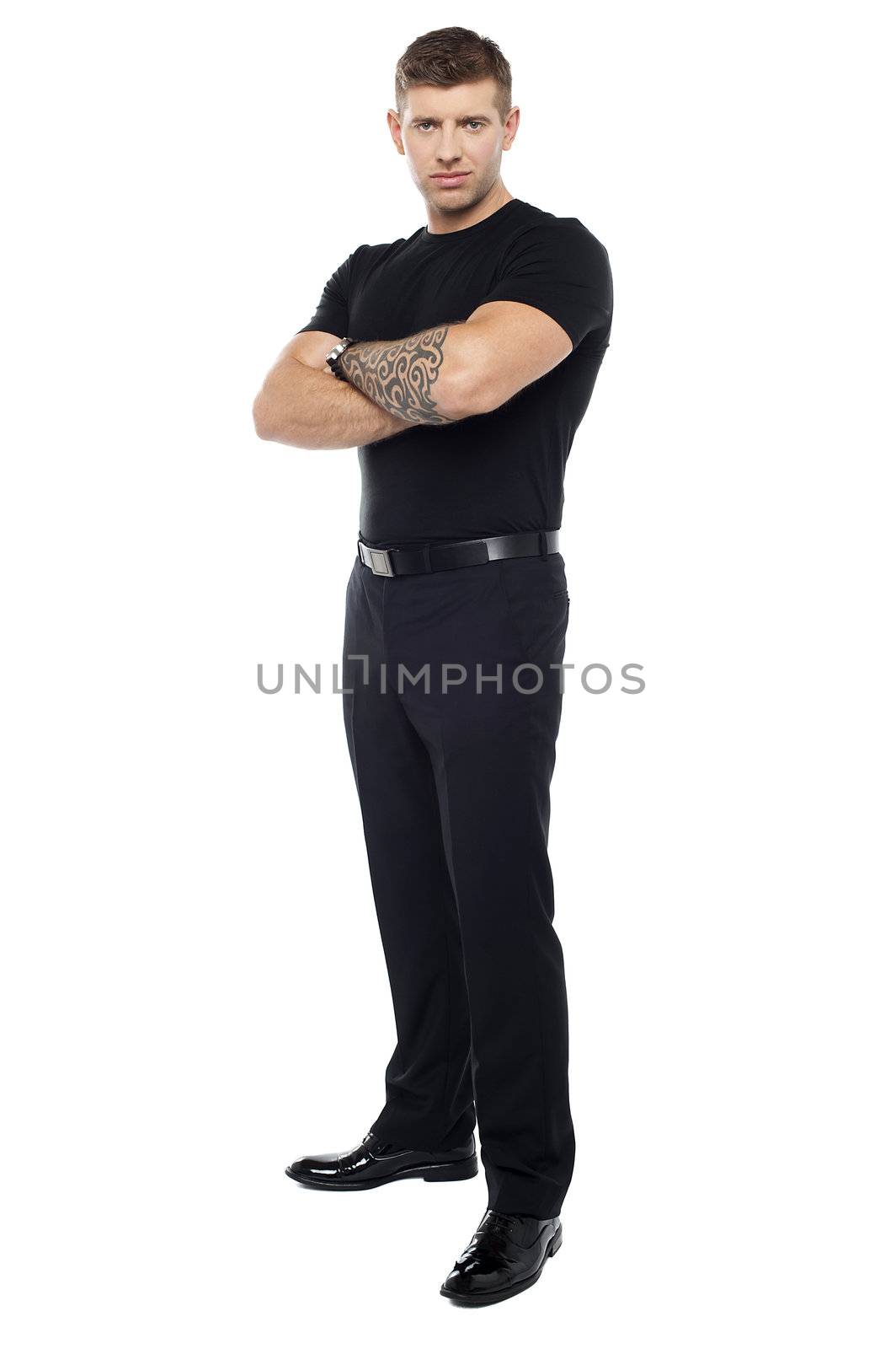 Bouncer with tattoo on hand posing with arms crossed isolated against white background