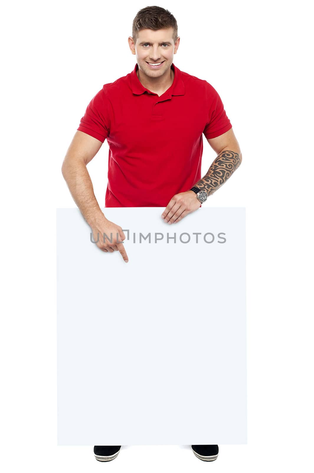 Young guy pointing at the billboard, full length shot over white background