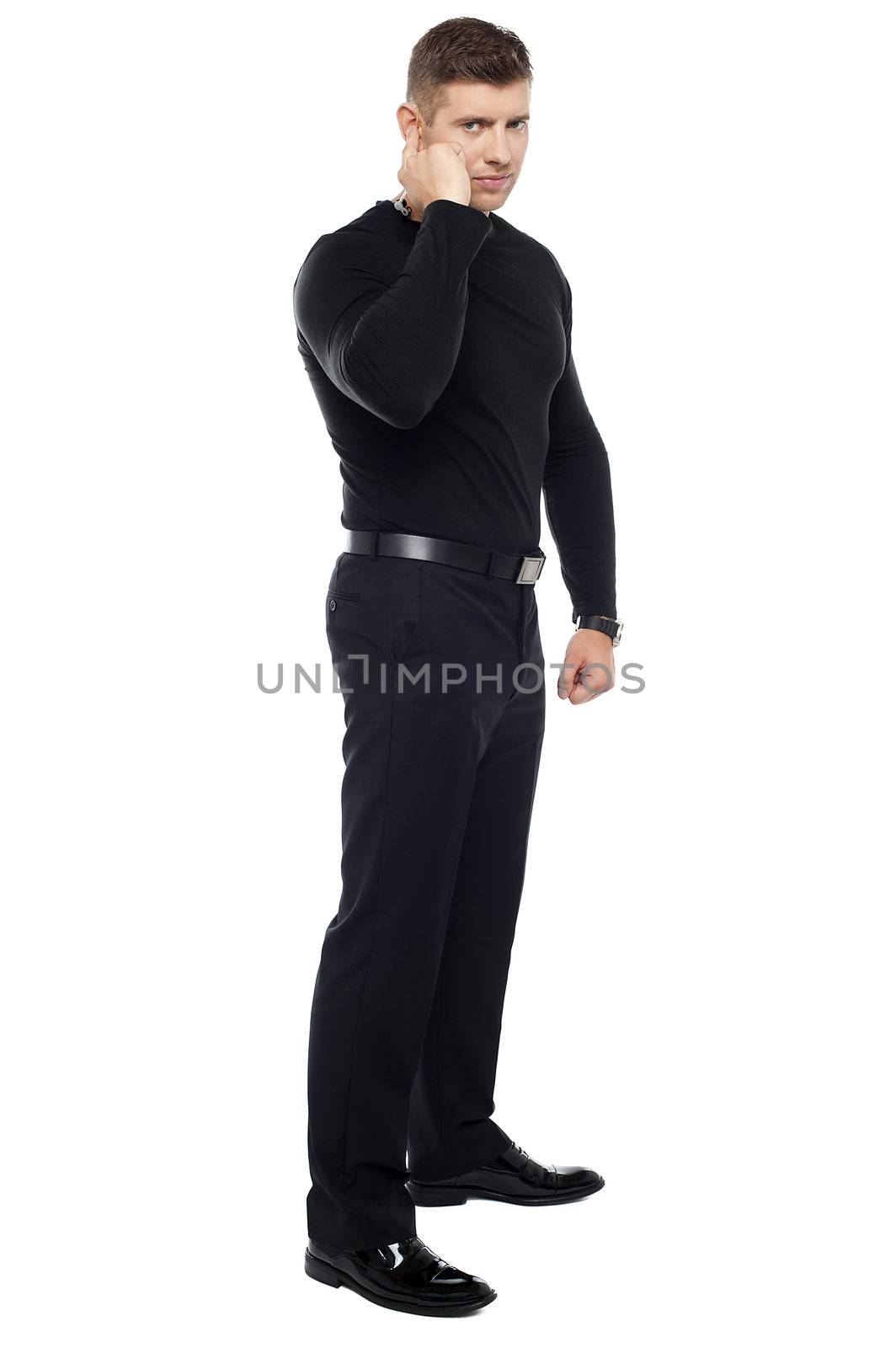 Strong bouncer listening carefully. Full length shot over white background