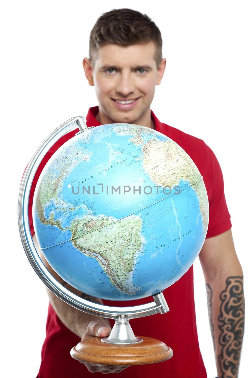 Guy with tattoos showing globe to camera isolated on white background