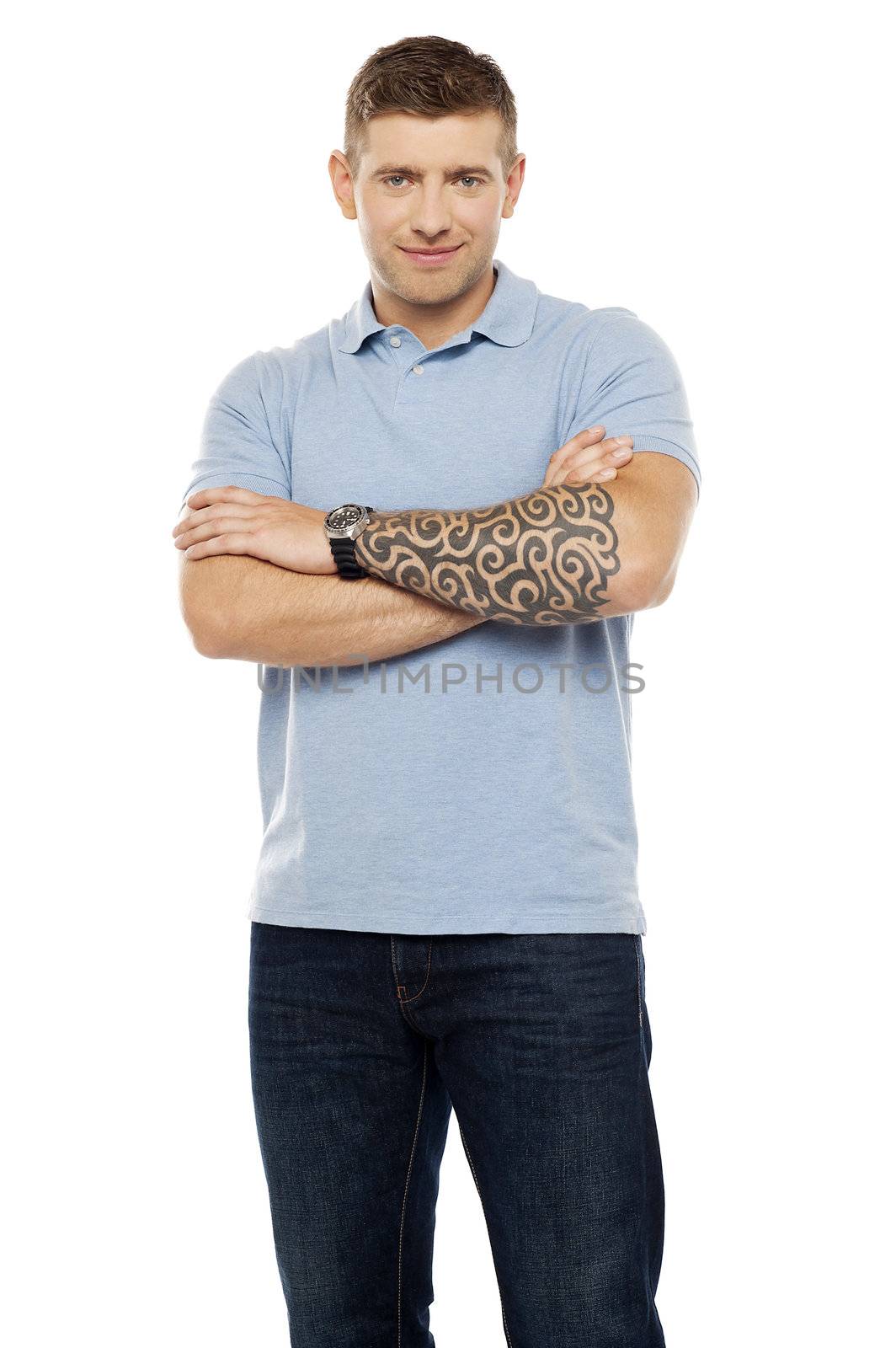 Casual man with artistic tattoo drawn on hand posing with arms crossed