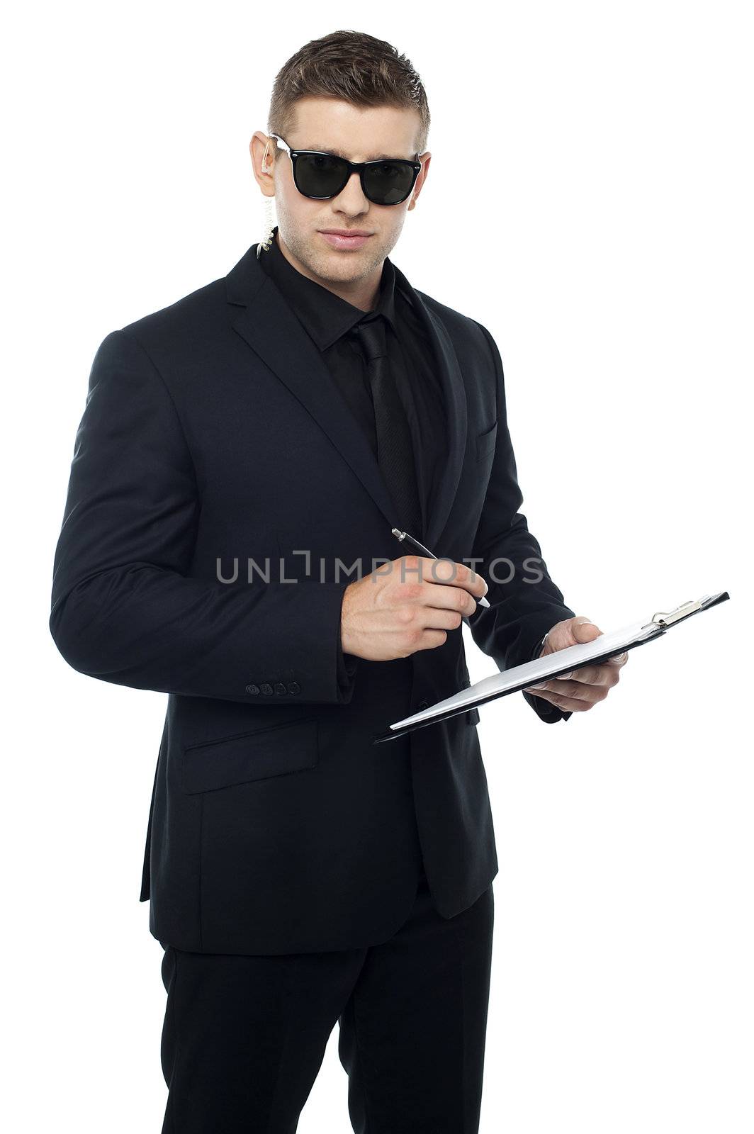 Security officer writing on clipboard while looking at you