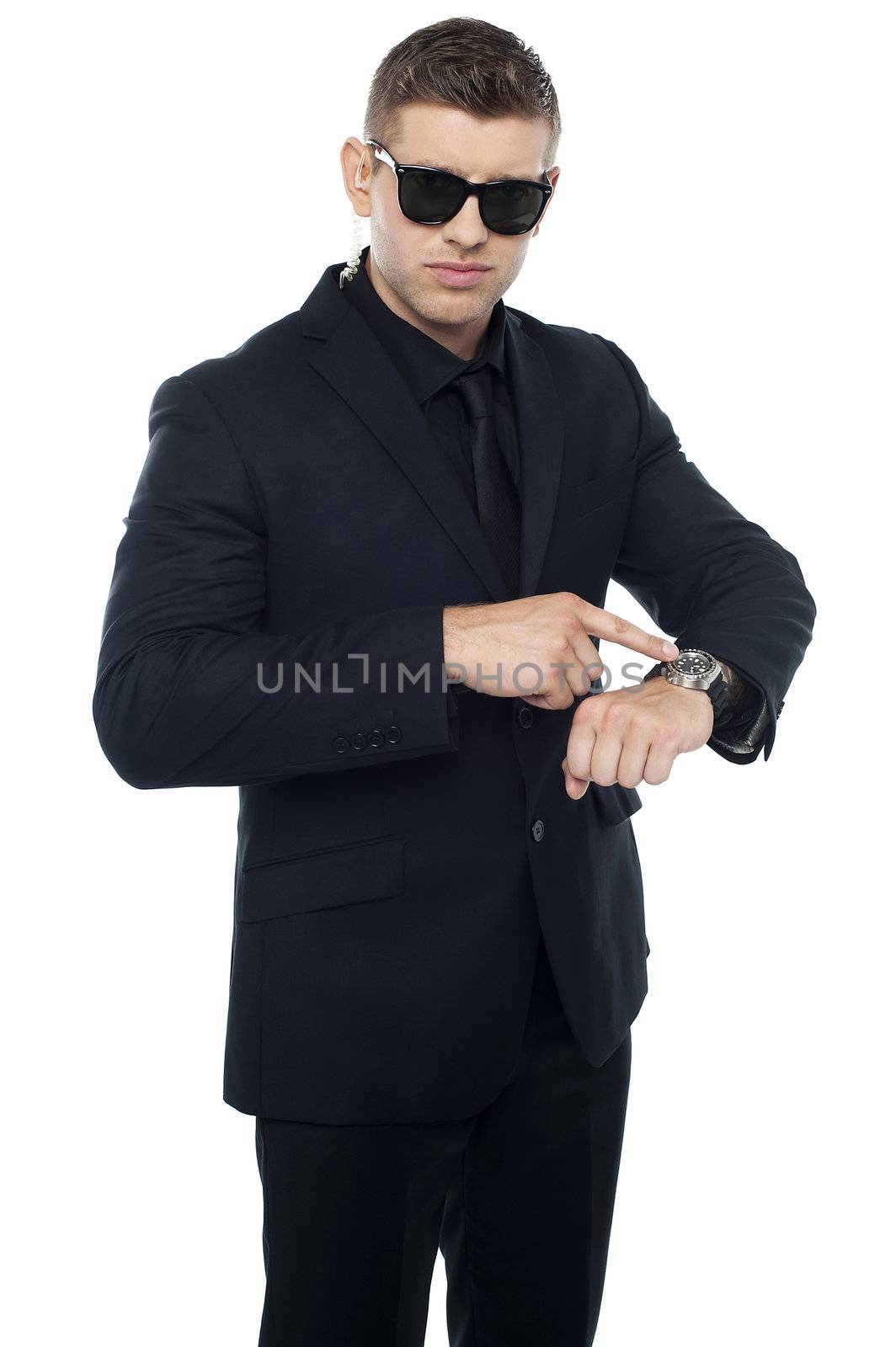 Security official pointing at his watch isolated against white background