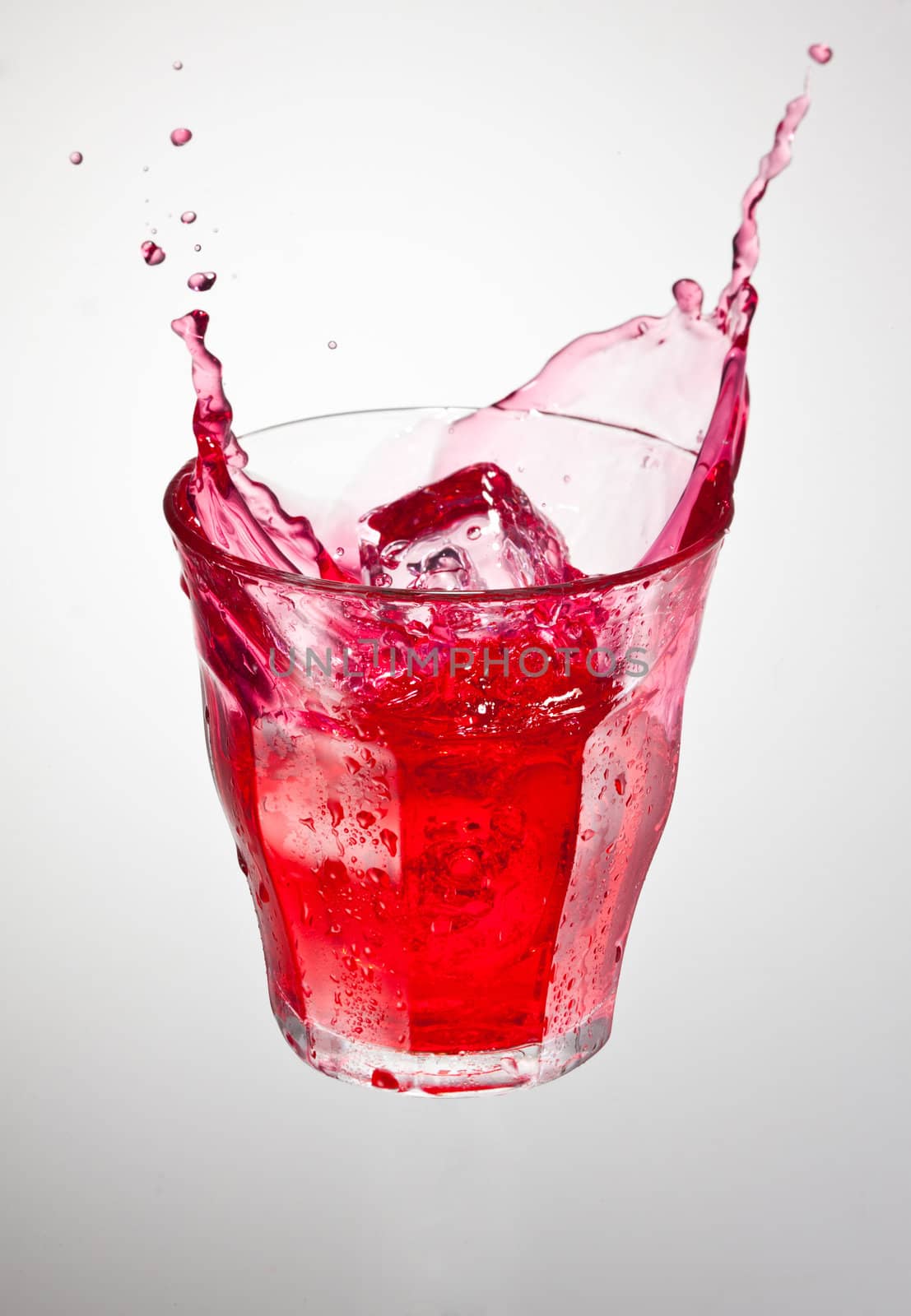 glass of red cranderry carbonated drink