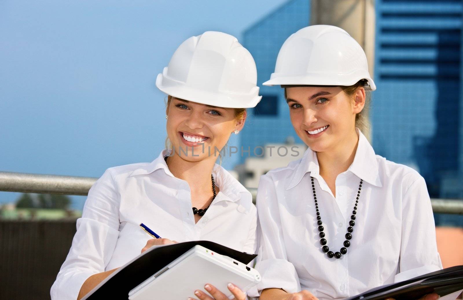 female contractors in a front of building site (focus on blonde)