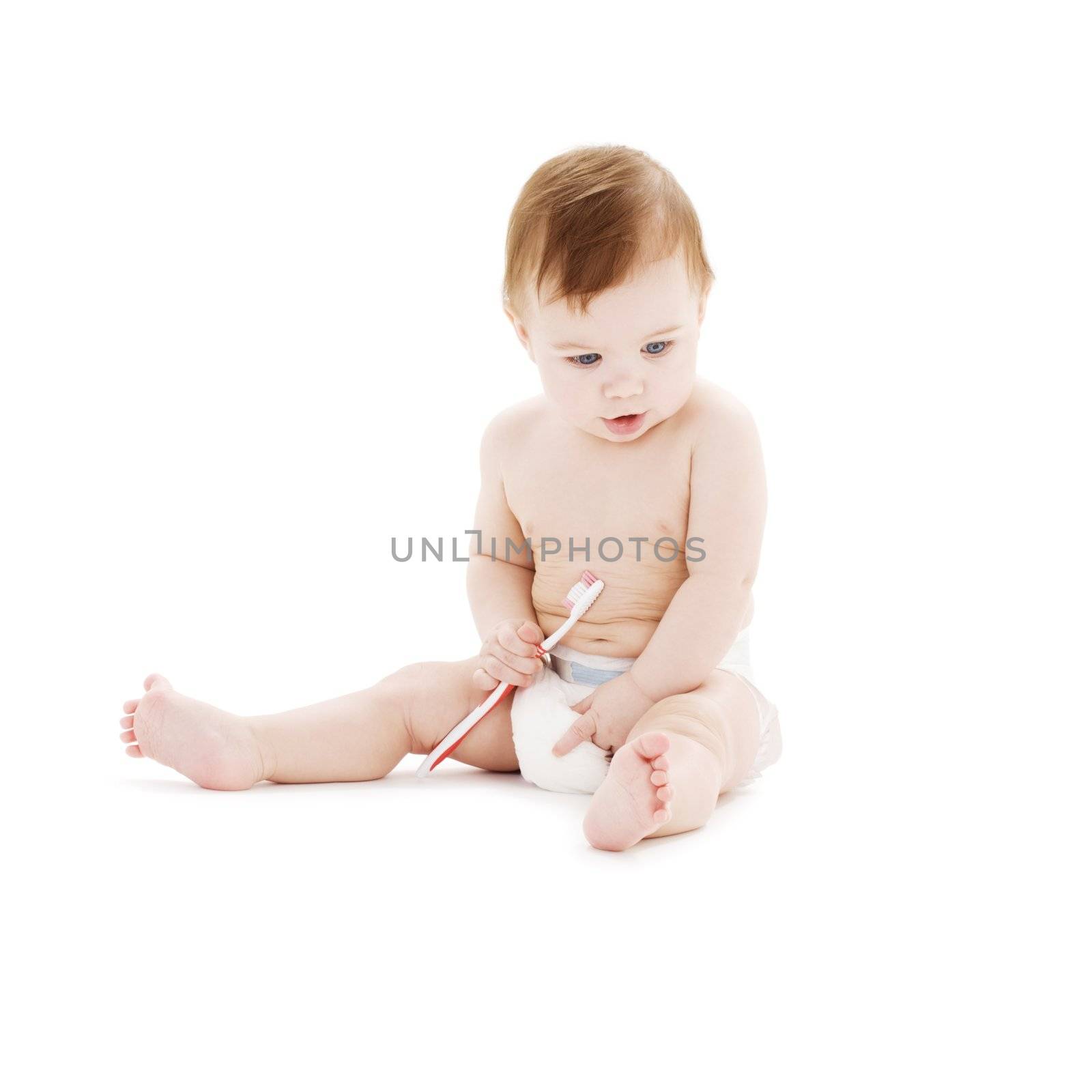 baby boy in diaper with toothbrush by dolgachov