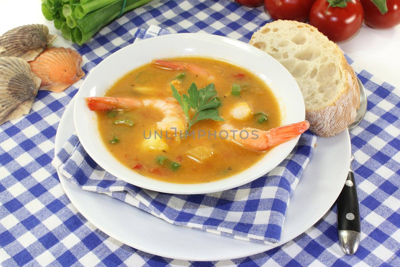 a bowl of bouillabaisse with shrimp and mussels