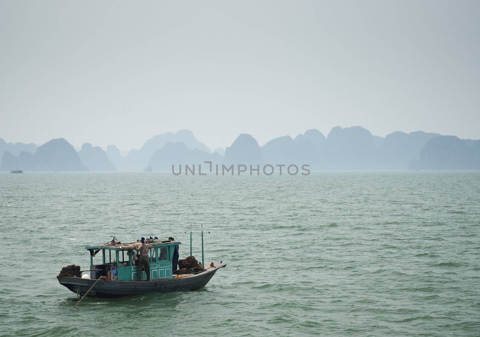 boat on halong bay in vietnam by jackmalipan