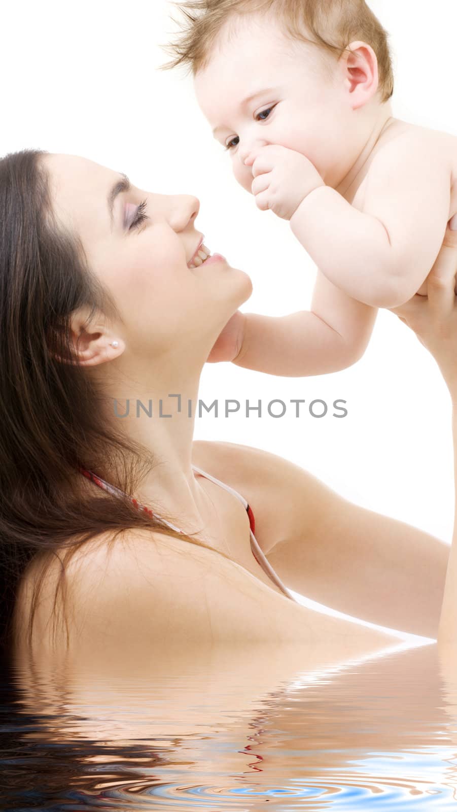 picture of happy mother with baby in water (focus on baby)