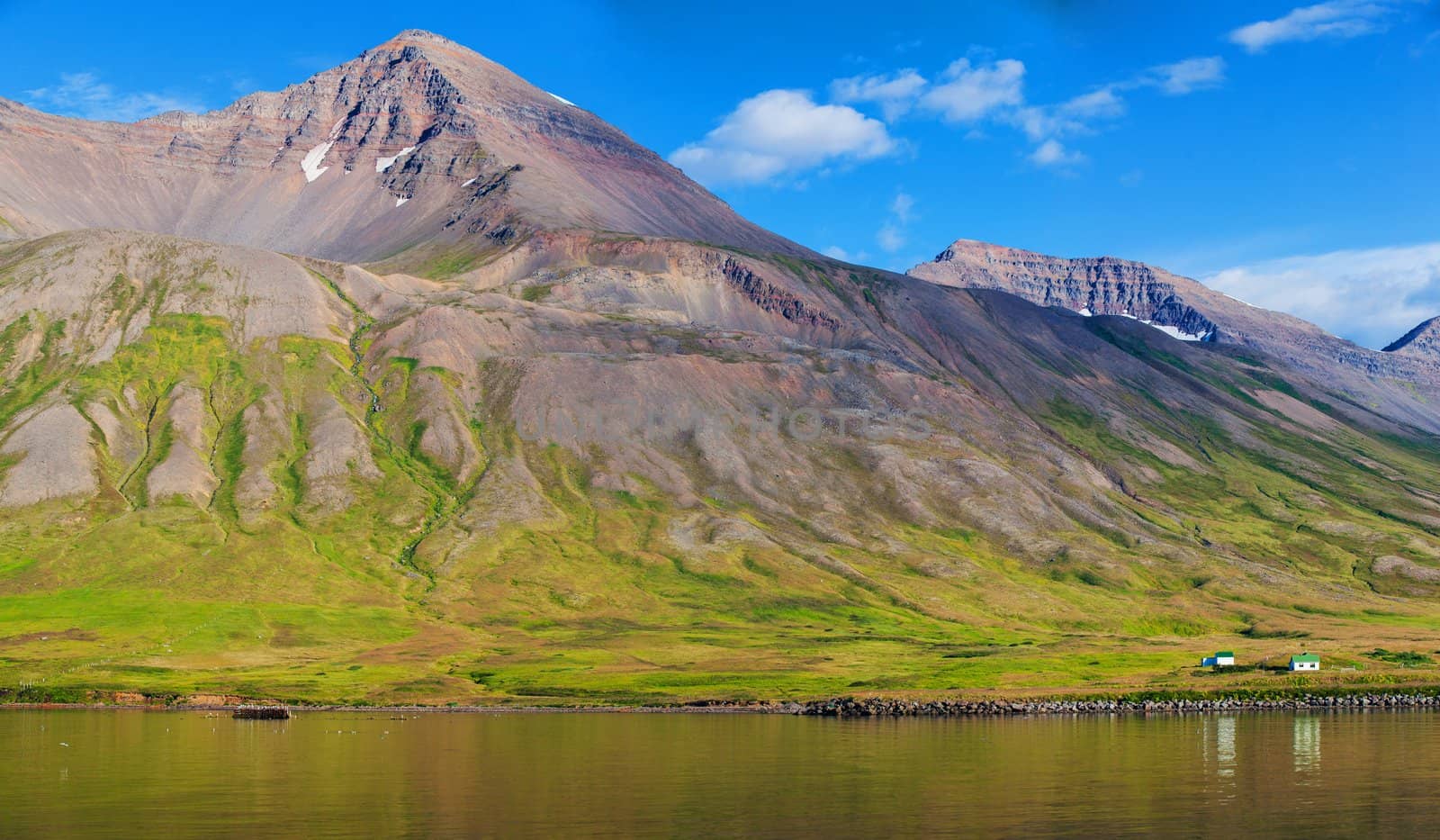 Beautiful landscape, Iceland. Houses, mountain, sea, sky