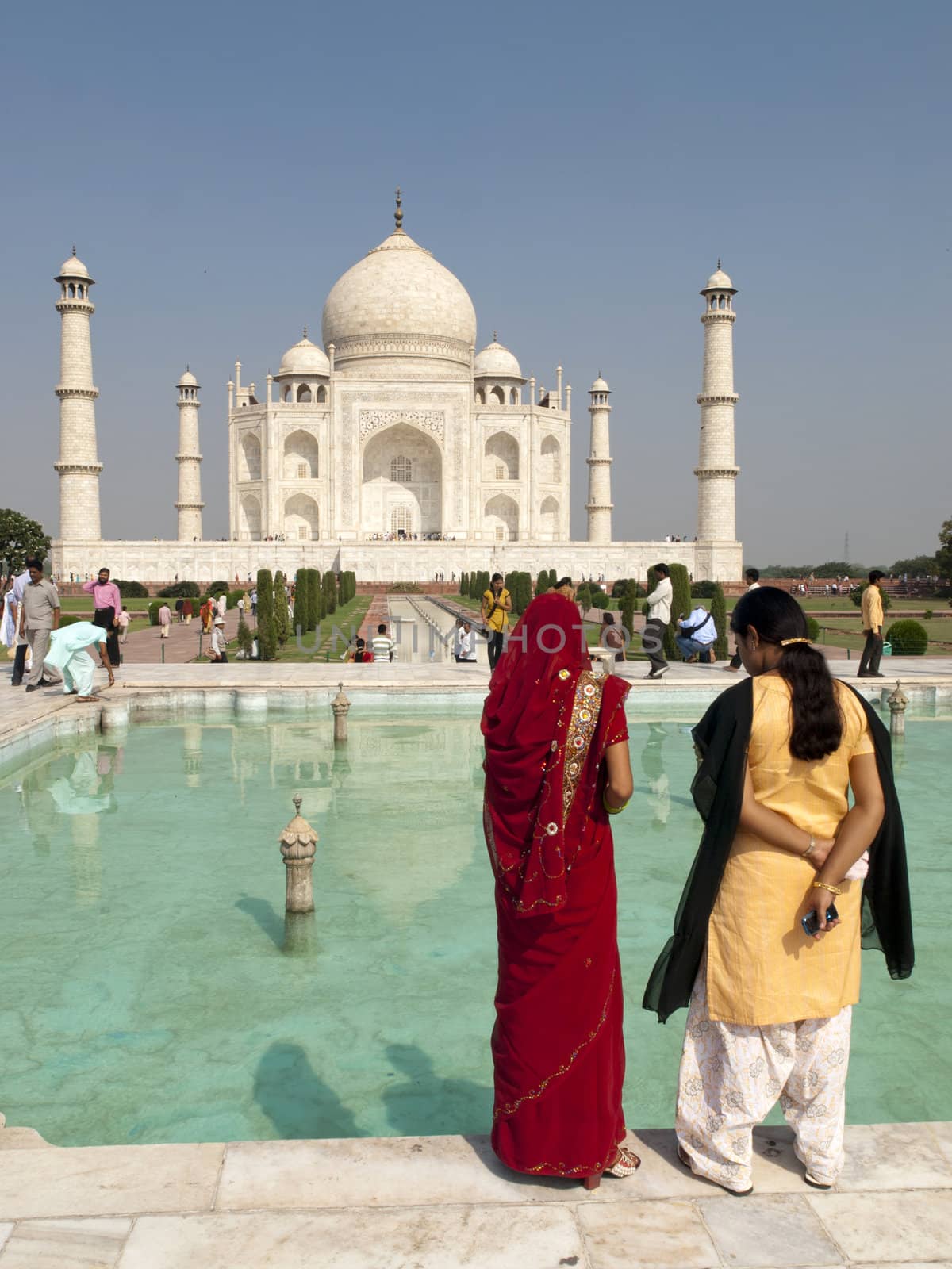 TAJ MAHAL, AGRA, INDIA - NOV 6: Unidentified local woman look at the white marble mausoleum of the Taj Mahal, Agra, India on Nov 6, 2009.