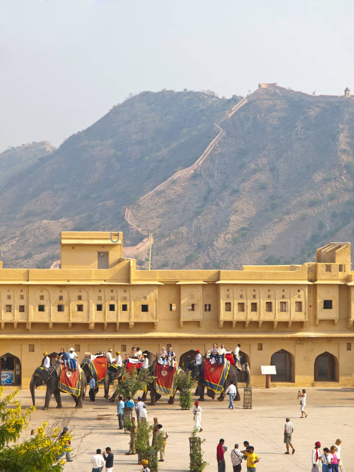 AMBER, INDIA - 7 NOVEMBER, 2009: Indian elephant riders wait for tourists behind the wall of Amber Fort on November 7, 2009. 