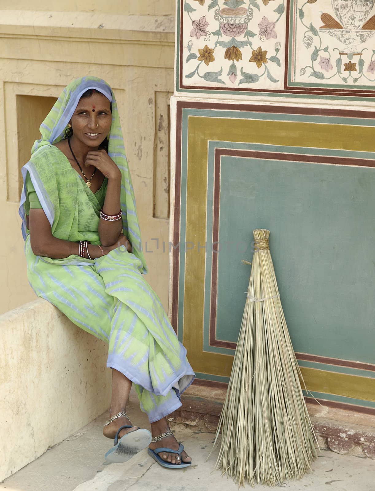 Local India woman have some rest durin her work as sweeper